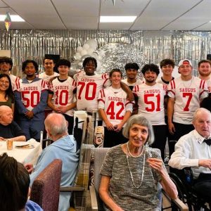 THE SAUGUS HIGH FOOTBALL TEAM joined Chestnut Woods Rehabilitation & Healthcare Center residents and staff for a “Senior Homecoming” on September 26. (Courtesy photo to The Saugus Advocate)