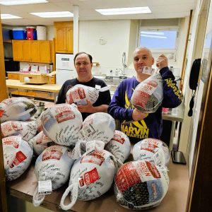 TURKEY TIME: Volunteers at the Saugus United Parish Food Pantry stacked some of the turkeys that were distributed to needy Saugus area families last year so they could have a home-cooked Thanksgiving Day meal. Volunteers of all ages – including Saugus High School football players and cheerleaders – are expected tomorrow in the basement of Cliftondale Congregational Church. (Saugus Advocate file photo by Mark E. Vogler)