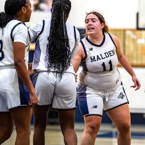 Team Captain and senior guard Angie Colon (11) fired up her teammates on the sideline in a recent game versus Lynn Classical.