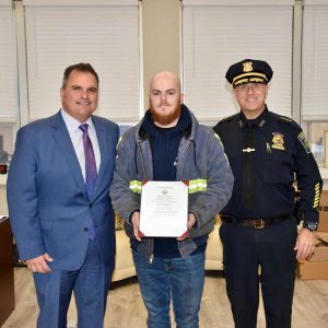 Mayor Carlo DeMaria and Chief of Police Paul Strong presented a Citation to Derek O’Brien on behalf of the City of Everett for helping save a man’s life after a vehicle fell on him while he was attempting to change a tire. (Photo courtesy of the City of Everett)