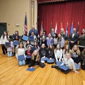 U12 CHEERLEADERS: At Tuesday night’s Board of Selectmen’s meeting, the girls on the Saugus Pop Warner U12 cheerleading team, led by Head Coach Charlene Berridge, celebrated with the Board of Selectmen their sixth overall finish in national competition in Florida after capturing first place in state competition and third place in the regionals. (Saugus Advocate photo by Mark E. Vogler)