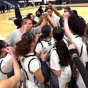 Victory is theirs as Malden High Head Coach Scott Marino huddles with players after a big win over Lowell.