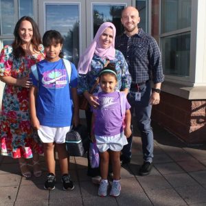 WELCOME BACK: Kindergartener Reem, 5, fifth-grader Noor, 10, and Fatima Ramzy with Assistant Principal Tiffany Boakye and K-8 Head Teacher Joseph Marchesi.