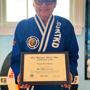 Virginia Grace Rooney displays the plaque