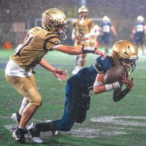 Senior Matthew Candelario Da Costa holds on for a 21-yard reception in Malden’s home loss to Whittier Tech. (Advocate Photo/Henry Huang)
