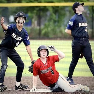 WHOAA! YOU SERIOUS RIGHT NOW? Malden sophomore Davante Layne (4) can’t believe they called Cam Fortier “safe” on this play; Billy Gavin is also having a moment. (Courtesy Photo)