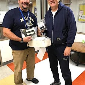Malden High School educator and Bicycle Club advisor Mitch Abbatessa (left) is shown receiving a donation of bicycle safety lights from Ward 6 Councillor Steve Winslow. (Courtesy/Malden Public Schools)
