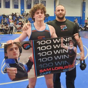 SHS Wrestling team Capt. Sam LoRusso celebrating 100 wins with Coach Mike Penta.