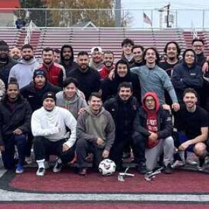 Everett High School boys soccer alumni, some 80 strong, pose for a team photo during the first annual Crimson Tide alumni game last Saturday at Everett Memorial Stadium.