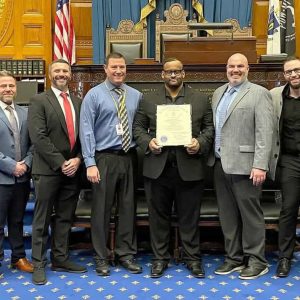 State Rep. Joseph McGonagle, pictured with EHS football coaches and state officials honoring Everett High School teacher and football coach Claudy St. Juste who was honored at the 2026 Black Excellence on the Hill ceremony at the State House.