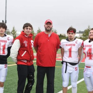 Saugus football captains shown at a game earlier in the season: Isaiah Rodriguez, Cameron Preston, SHS Head Coach Steve Cummings, Tommy DeSimone, and Braden Faiella. Missing from the photo is Danny Shea.