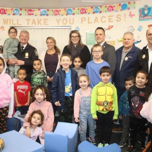 Shown from left to right: Library Trustees Chair Mark Ferrante, Police Chief David Callahan, School Committee Member Anthony Caggiano, Mayor Patrick Keefe, Children’s Librarian Lisa Ferrara and State Rep. Jessica Giannino. Shown center: Willow Parent and Jarielys and Jasmin Lora.