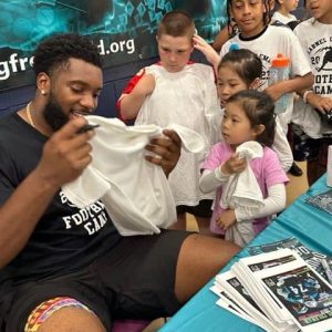 SIGN OF THE TIMES: Carolina Panther and Malden native Larnel Coleman signs autographs for some starstruck fans. (Advocate Photos)