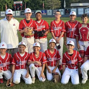 The 2025 Saugus Little League Williamsport 11–12-year-old all-star team is, from left, front row, Aarav Saini, Cadin Arsenault, Gio Natalucci, Jake Amodeo, Mason Botta, Luca Beatini and Thomas Streeter. Second row, assistant coach John Benoit, manager Jeff Natalucci, John Benoit, Henry Rodriguez, Owen O’Connell, Matty Benoit, Thomas Vitiello and assistant coach Sal Beatini. (Courtesy photo)