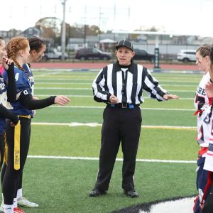 State Representative Steve Ultrino is shown refereeing the annual Powder Puff Flag Football game between Revere High School Patriots and the Winthrop Vikings at Miller Field last weekend. The Lady Pats routed Winthrop, 22-0 thanks to the fair and balanced officiating.