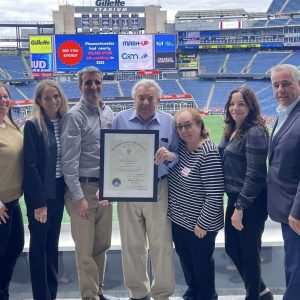 State Rep. Joe McGonagle is shown presenting a citation to Jack and John Perrino, shown with family and staff, owners of Ultimate Windows of Everett at the 9th Annual Manufacturing Awards Ceremony on Sept. 25 at the Mass. Manufacturing Mash-Up at Gillette Stadium in Foxboro.